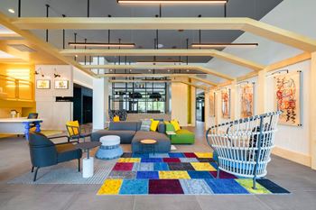 a living room with couches and chairs and a spiral staircase at The Chase at Bryant Street, Washington District of Columbia